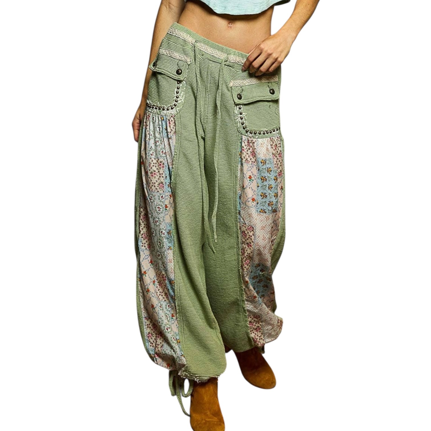 Green patchwork pants with floral patterns on a white background