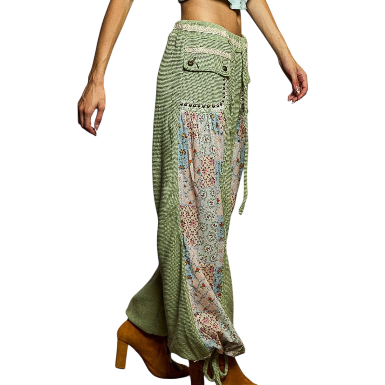 Green patchwork pants with floral patterns on a white background