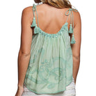 Green embroidered top with tassel straps on a white background