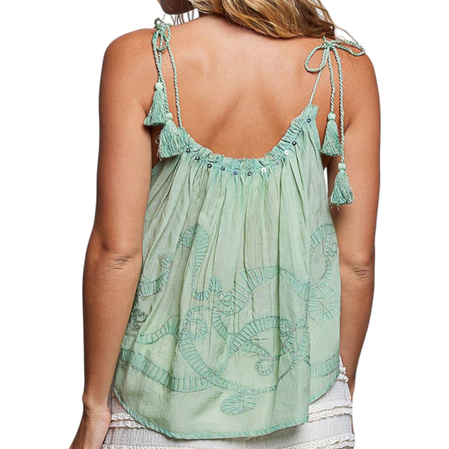 Green embroidered top with tassel straps on a white background