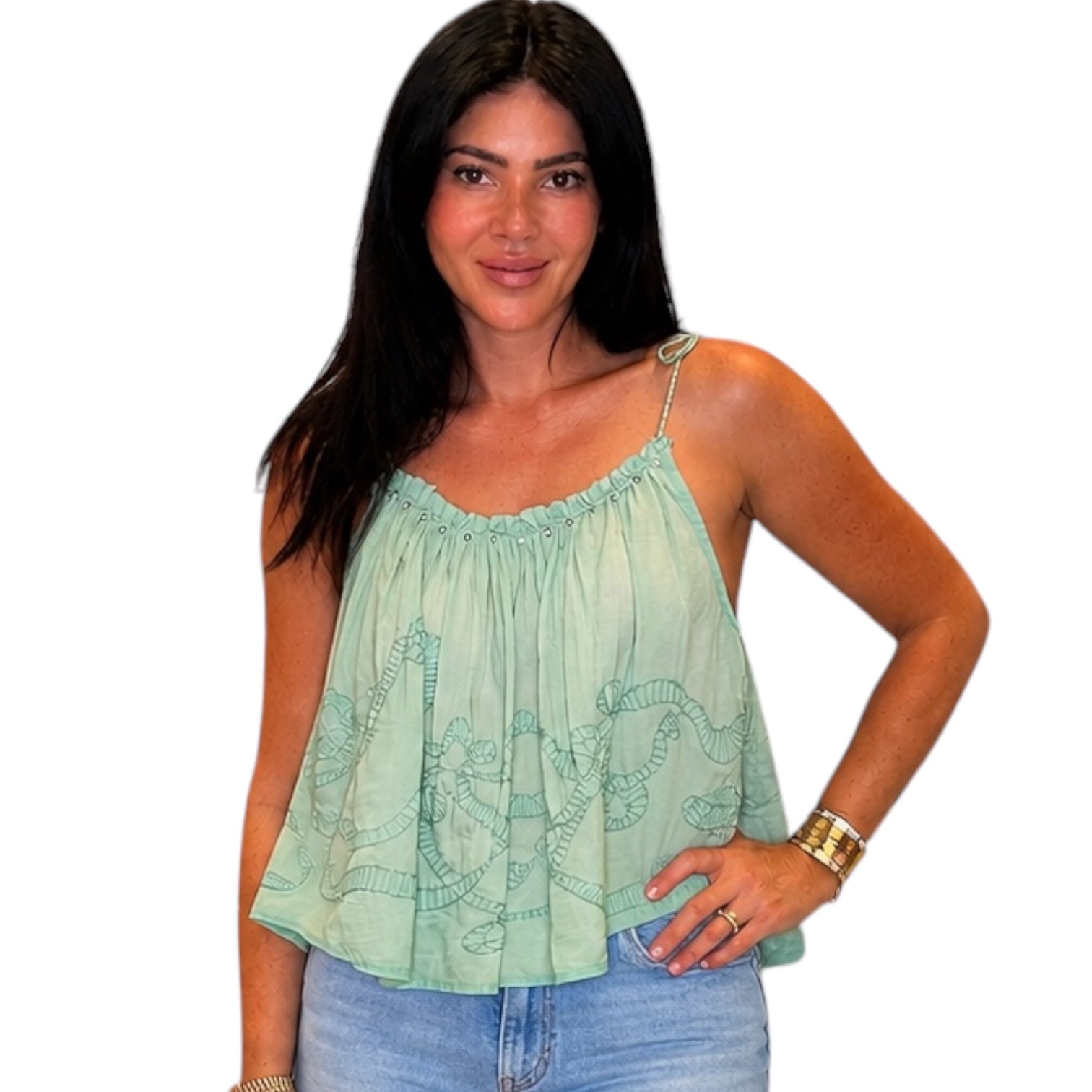 Woman wearing a light green sleeveless top with a white background