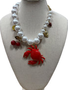 pearl necklace with crab, cherry, strawberry, coin and shell