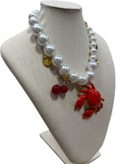 pearl necklace with crab, cherry, strawberry, coin and shell