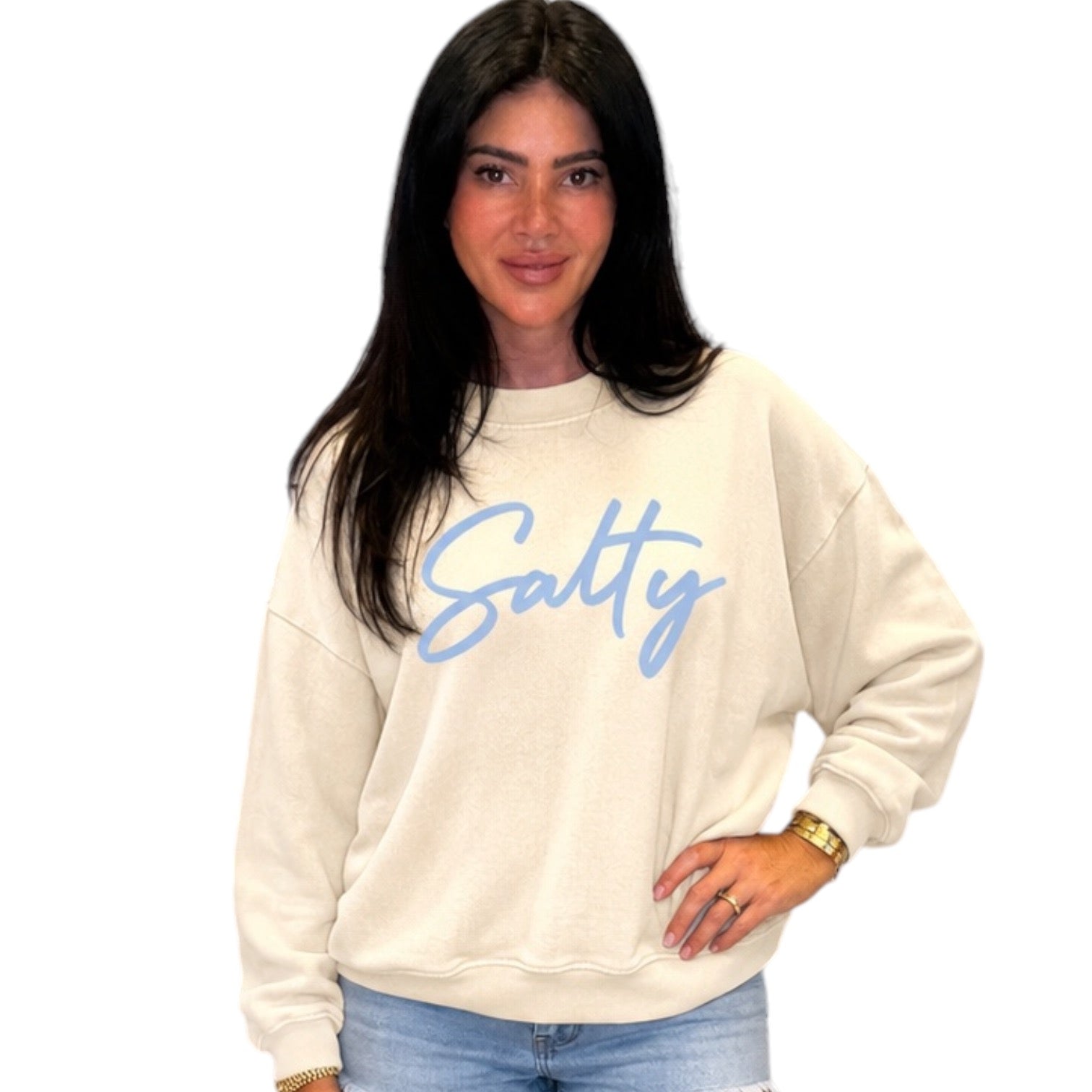 Woman wearing a beige sweatshirt with 'Salty' text on a white background