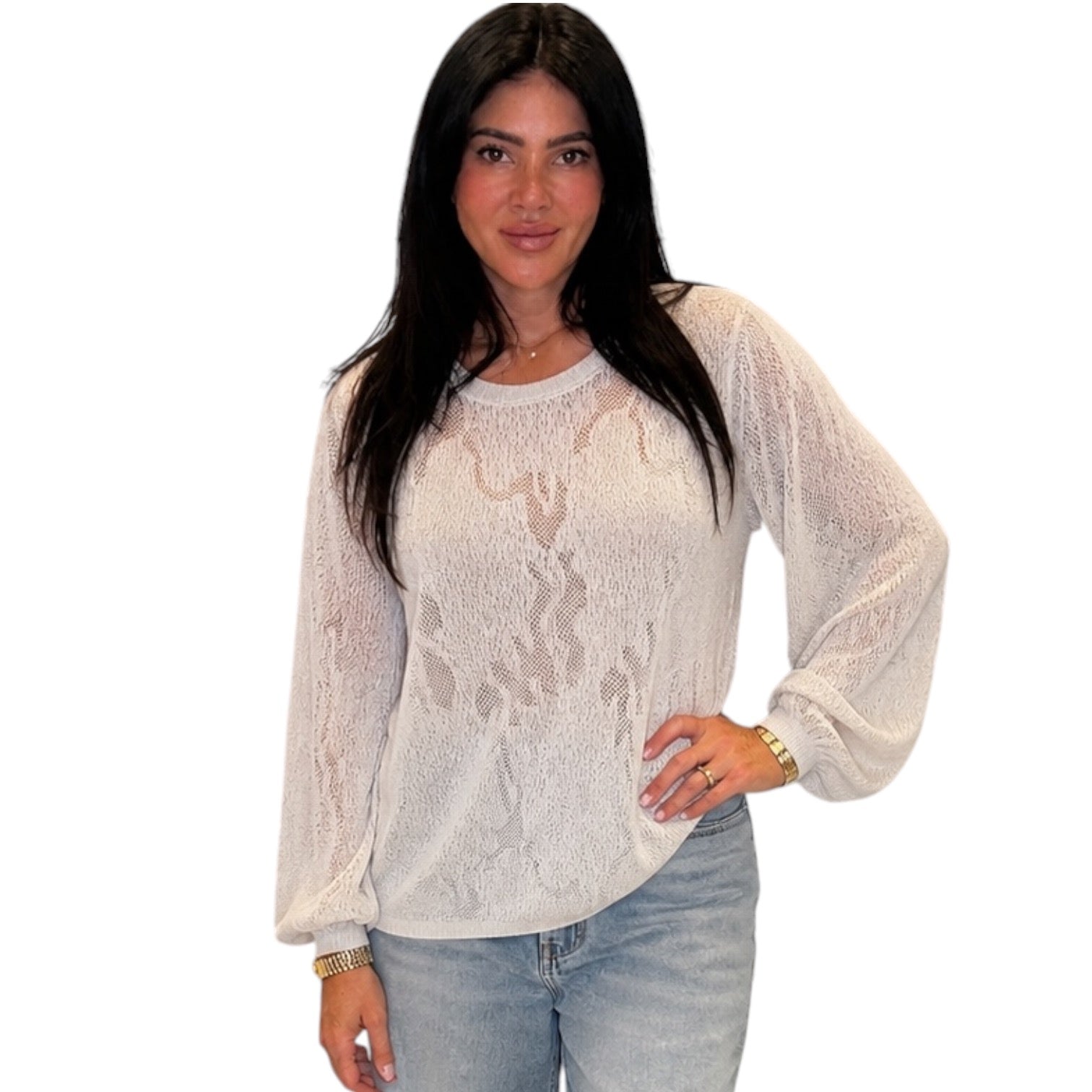 A woman modeling a beige long-sleeve lace top with balloon sleeves, paired with light-wash blue jeans, against a plain white background.