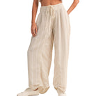 Beige striped pants worn by a person on a white background