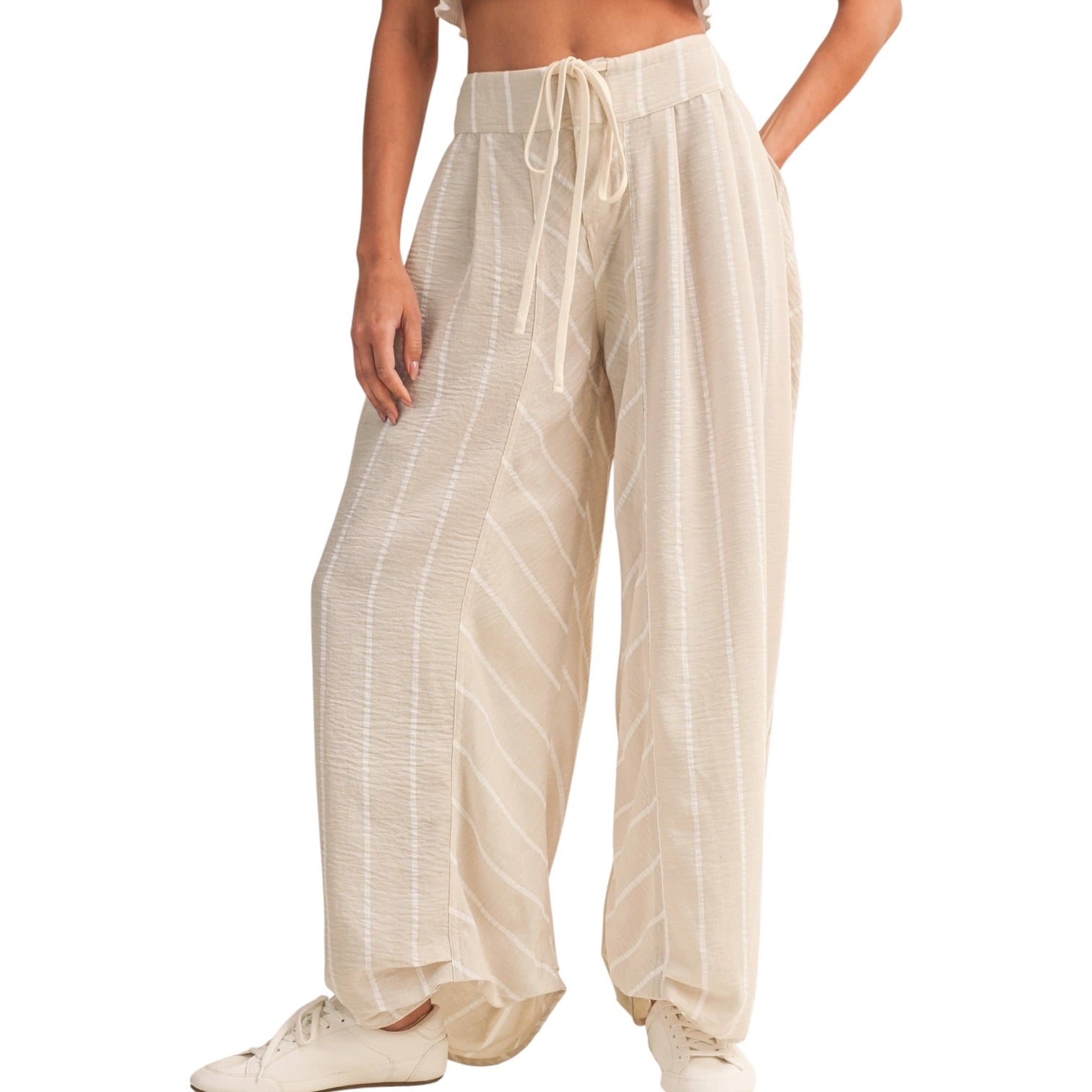 Beige striped pants worn by a person on a white background