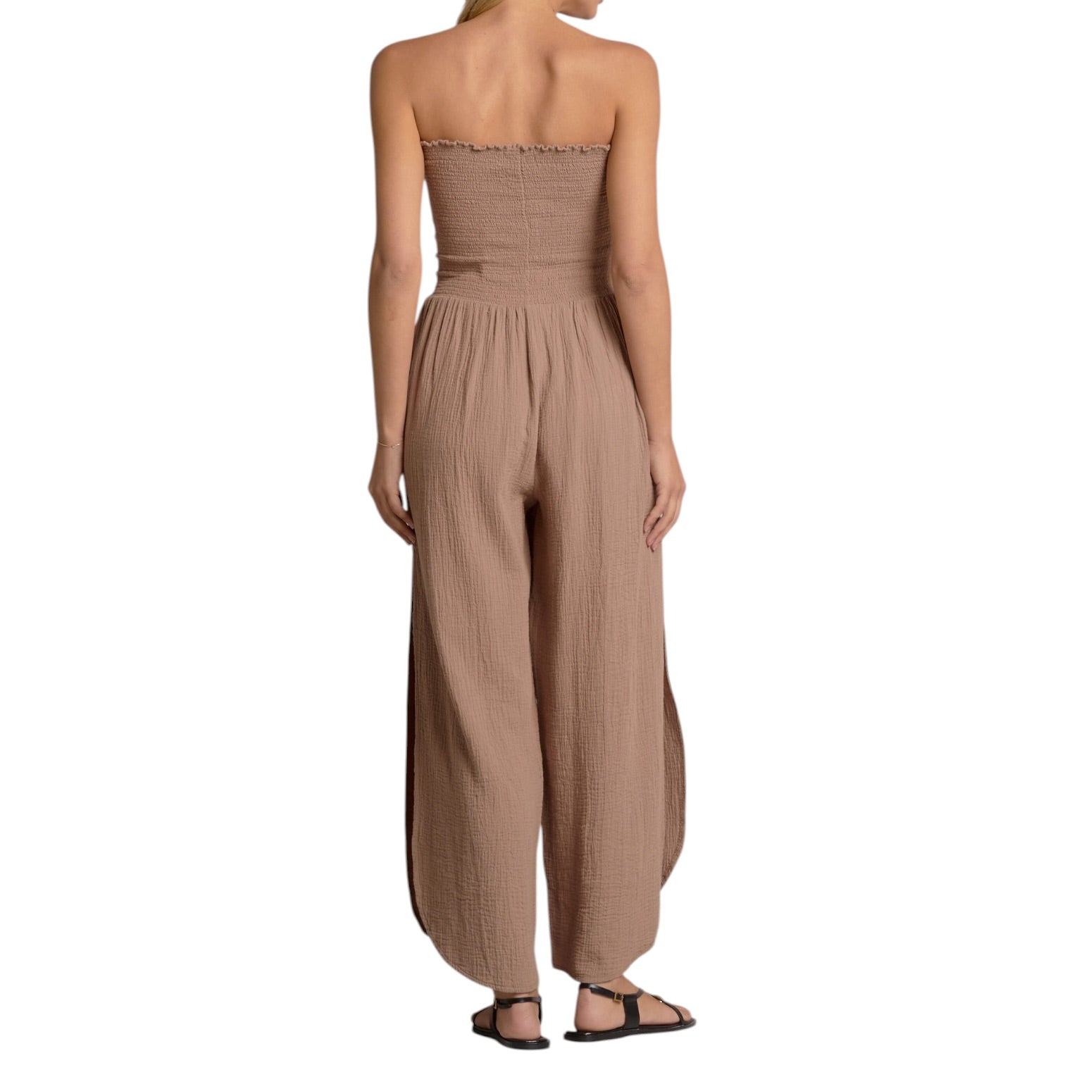 Beige strapless jumpsuit worn by a person on a white background