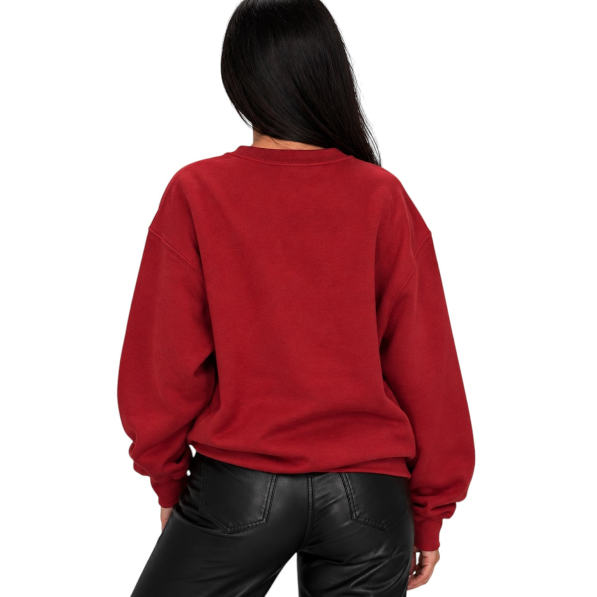 A woman viewed from behind wearing a red crewneck sweatshirt and black faux-leather pants against a plain white background.