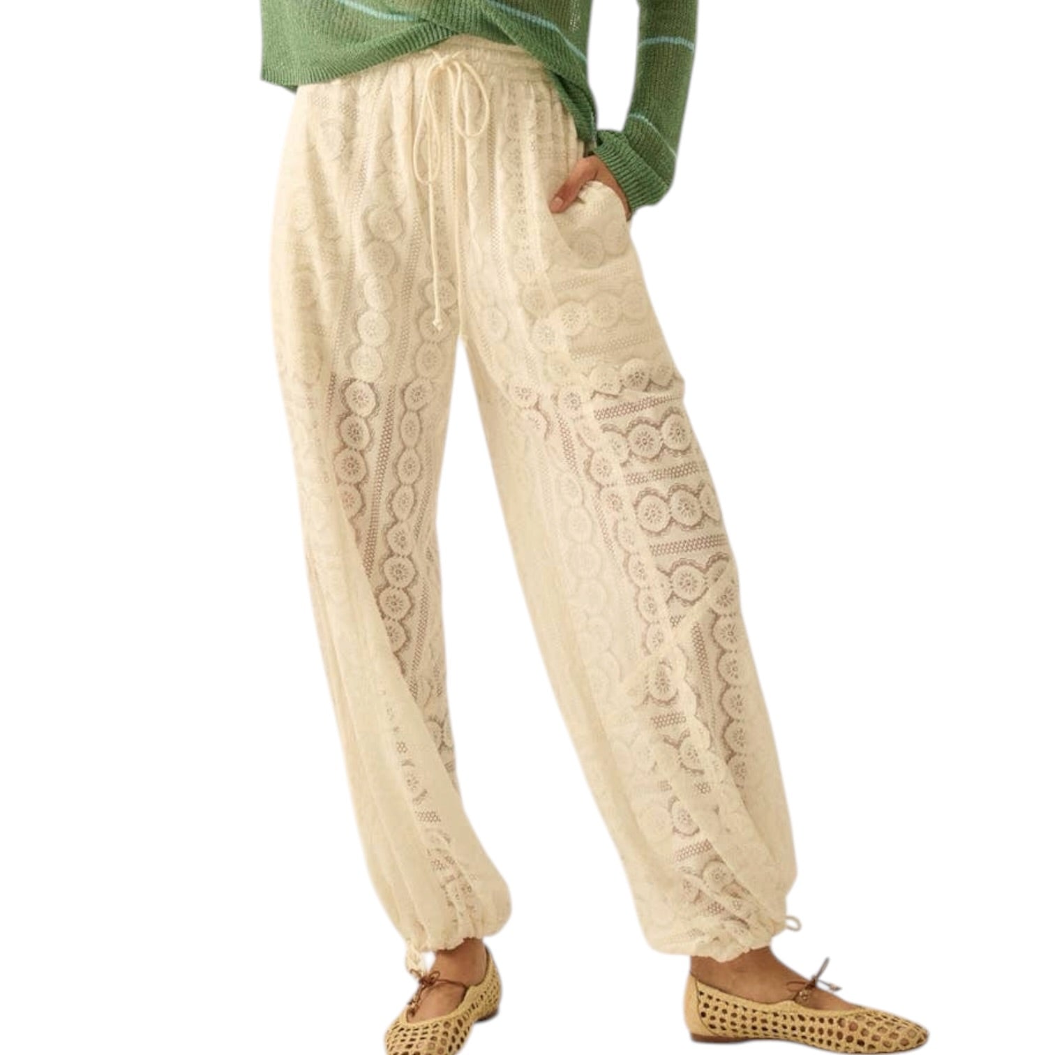 Beige cable knit pants worn by a person on a white background