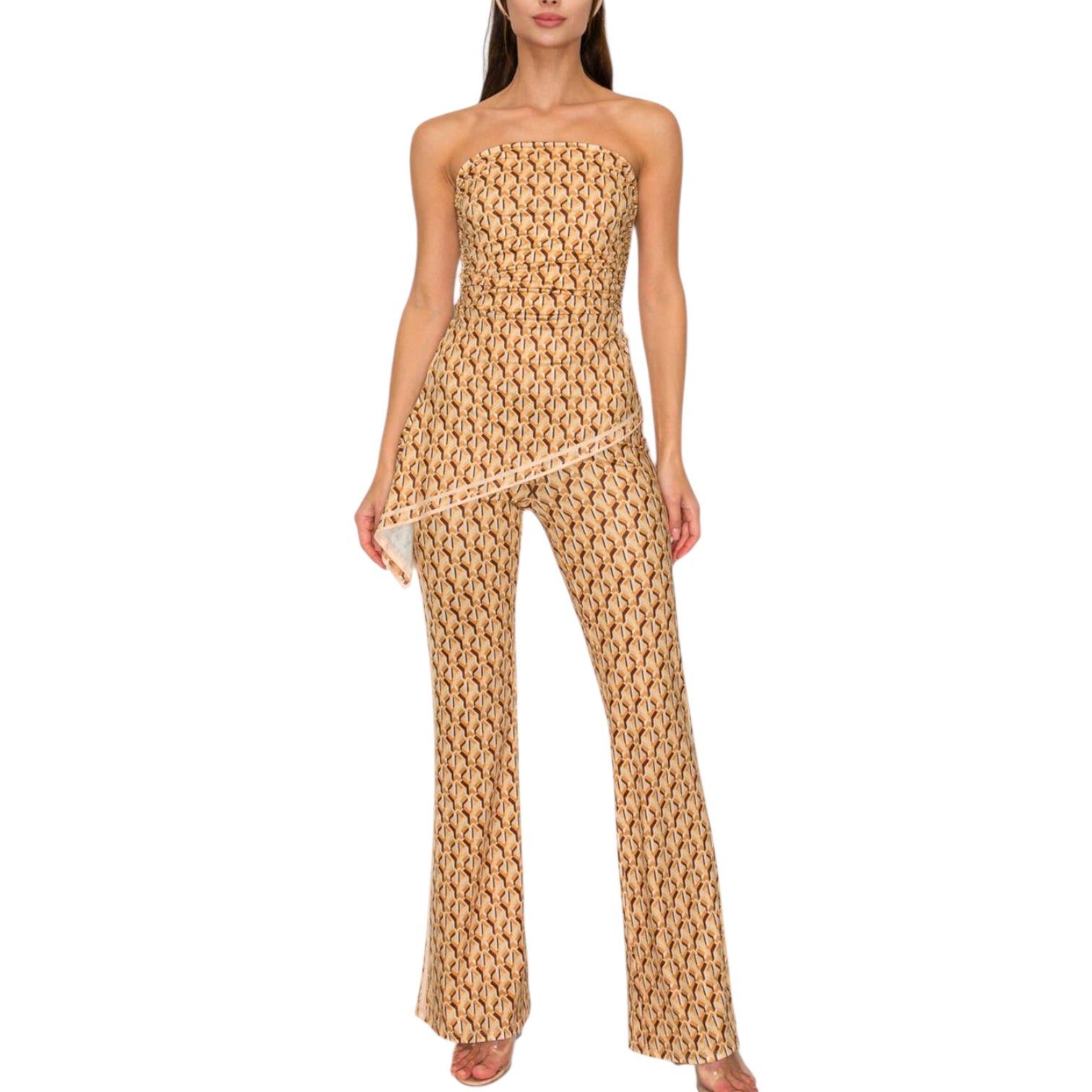 Woman wearing a beige strapless jumpsuit with a subtle pattern on a white background