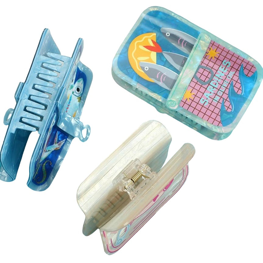 Two hair clips with colorful designs on a white background