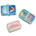 Three small claw clips with fish illustrations on a white background