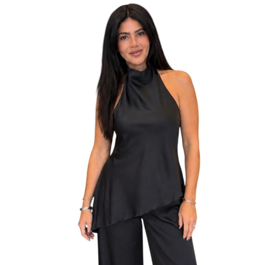 A woman modeling a black satin halter-neck top and matching wide-leg pants set against a plain white background.