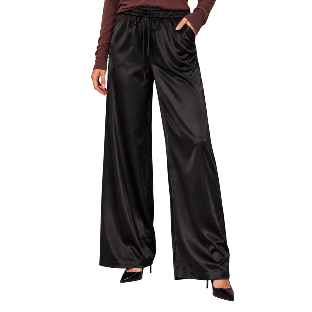 Black wide-leg satin pants with an elastic drawstring waist, modeled with a brown long-sleeve top and black heels on a white background.