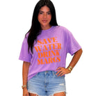 Person wearing a purple t-shirt with 'SAVE WATER DRINK MAROCS' text on a white background