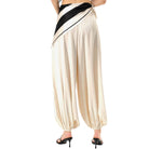 Beige wide-leg pants with black trim on a white background