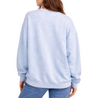 Light blue sweatshirt worn by a person on a white background