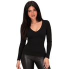 A woman modeling a fitted black long-sleeve V-neck top against a plain white background.
