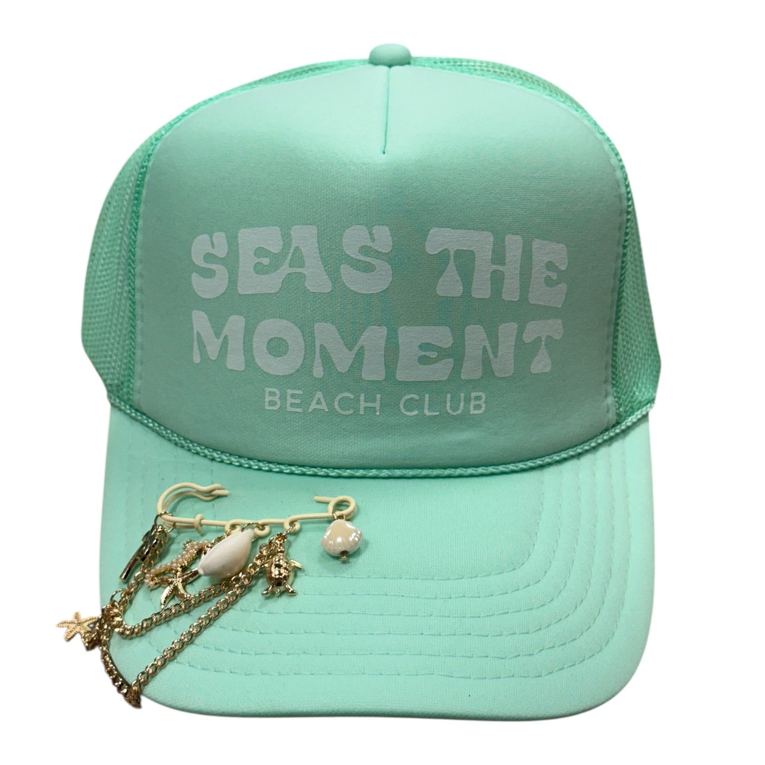 Mint green cap with 'Seas the Moment Beach Club' text and charm necklace on a white background