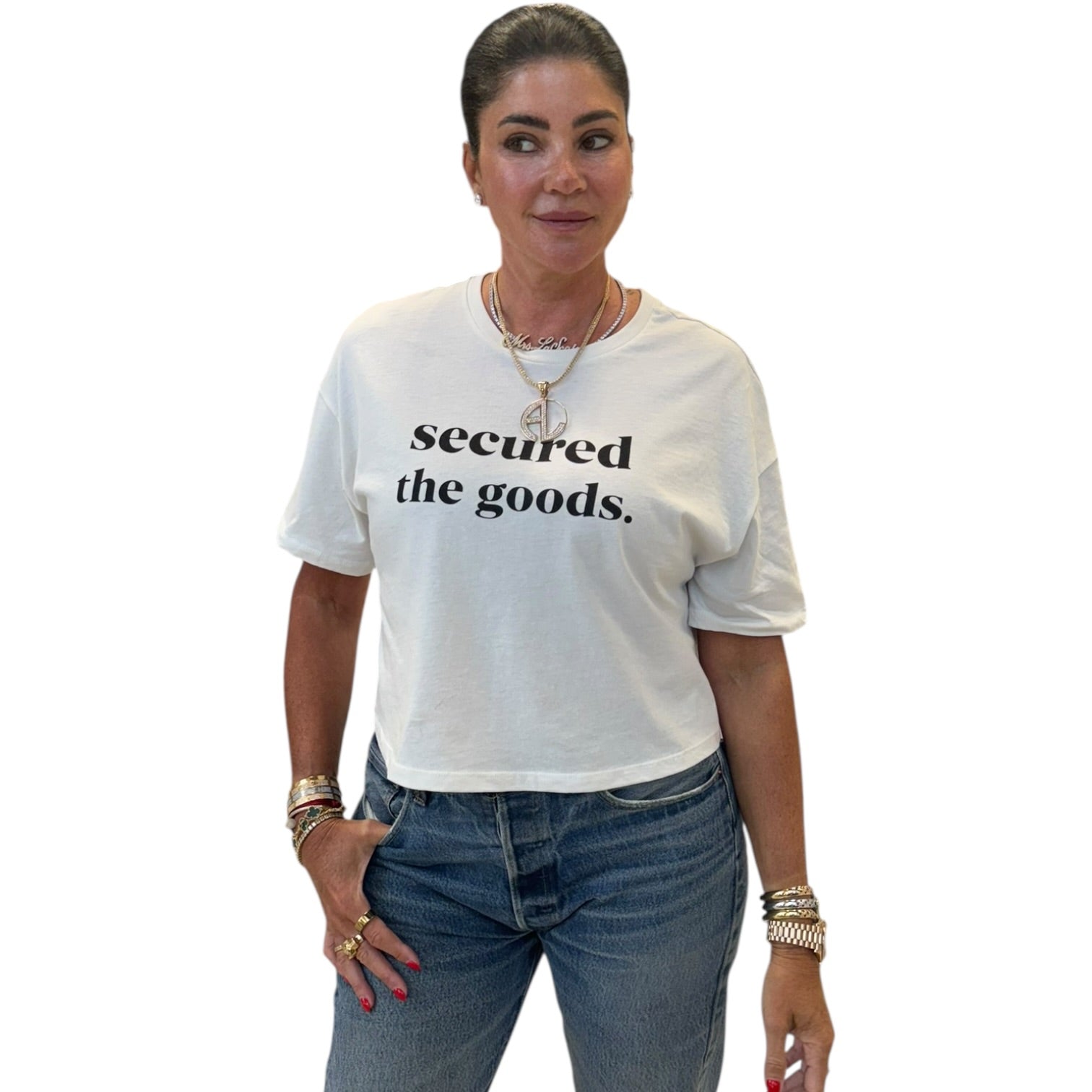 Person wearing a white t-shirt with 'secured the goods' text on a white background