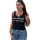 Woman wearing a black tank top with 'secured the goods.' text on a white background