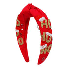 A red fabric headband featuring 'HO HO HO' lettering embellished with gold beads, white faux fur trim, and small red rhinestones, shown on a plain white background.