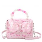 Pink handbag with bow design and chain strap on a white background