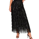 A black sequined maxi skirt with cascading fringe, shown on a model wearing black high-heeled sandals against a plain white background.