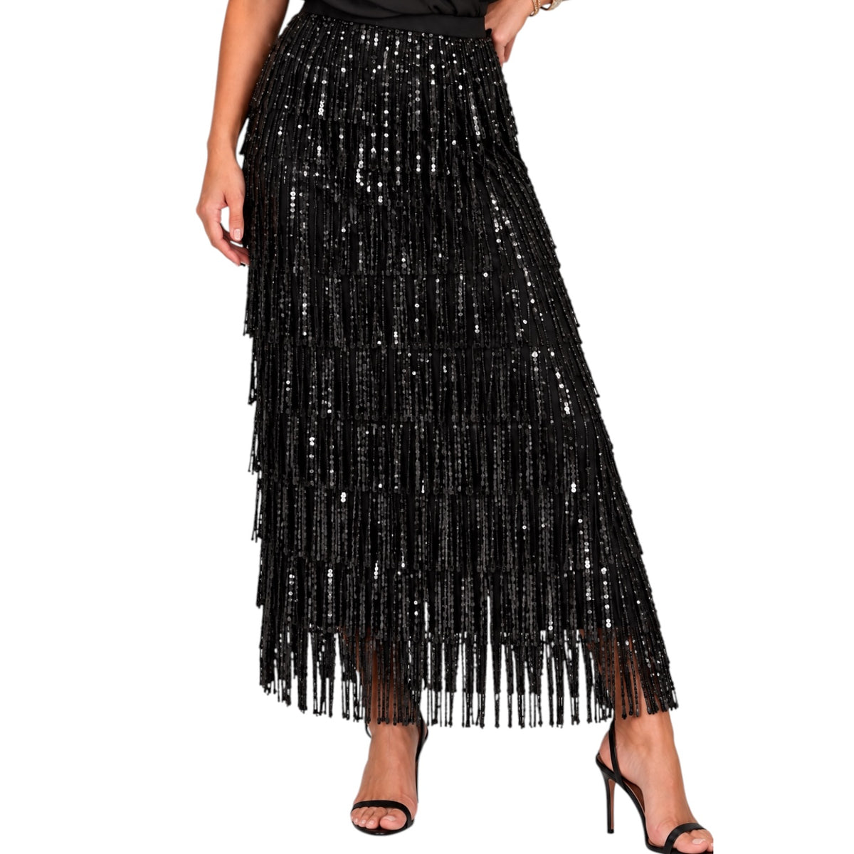 A black sequined maxi skirt with cascading fringe, shown on a model wearing black high-heeled sandals against a plain white background.