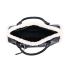 Black handbag with white fur lining on a white background