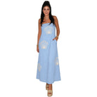Woman wearing a light blue dress with shell patterns on a white background