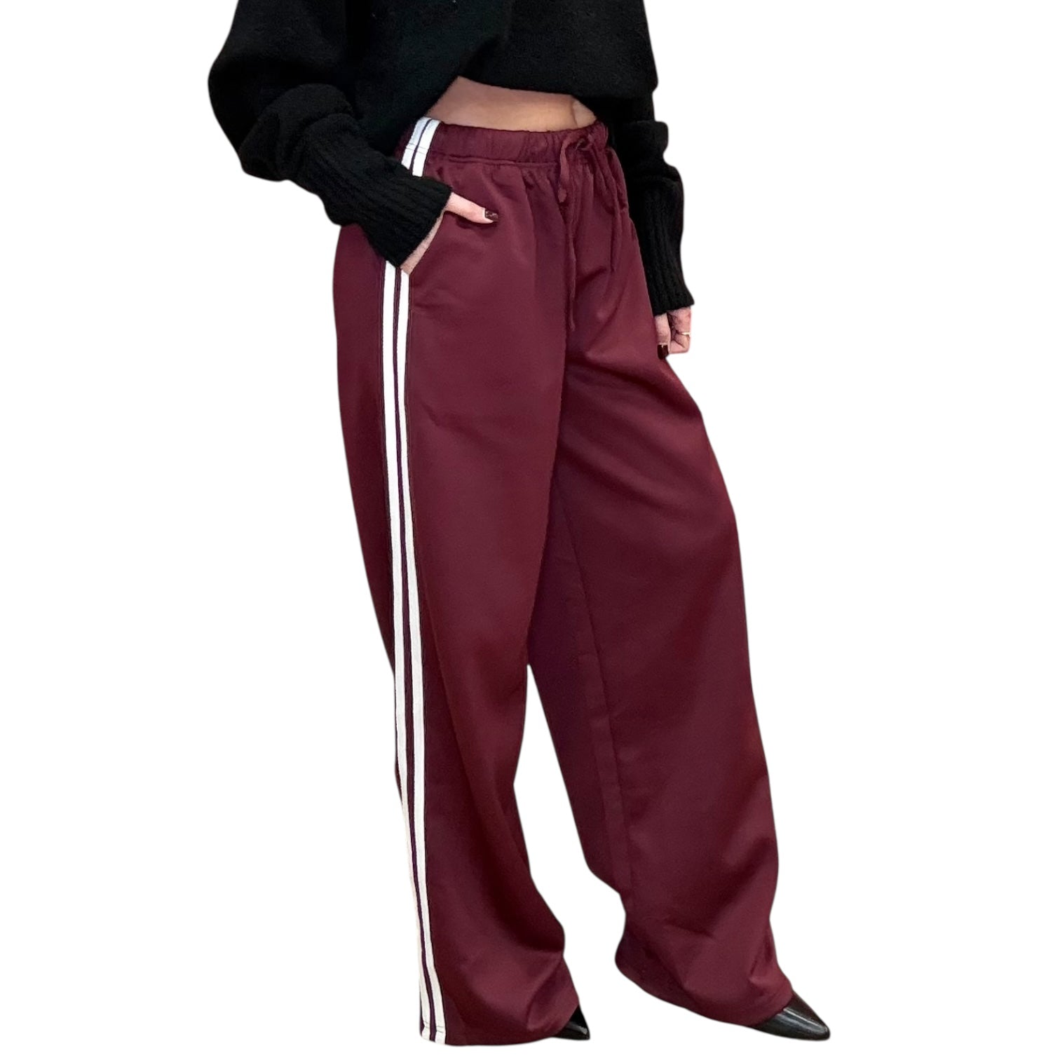 Maroon track pants with white stripes worn by a person on a white background