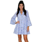 Woman wearing a light blue floral dress on a white background