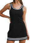 woman wearing black scuba dress with white trim on white background