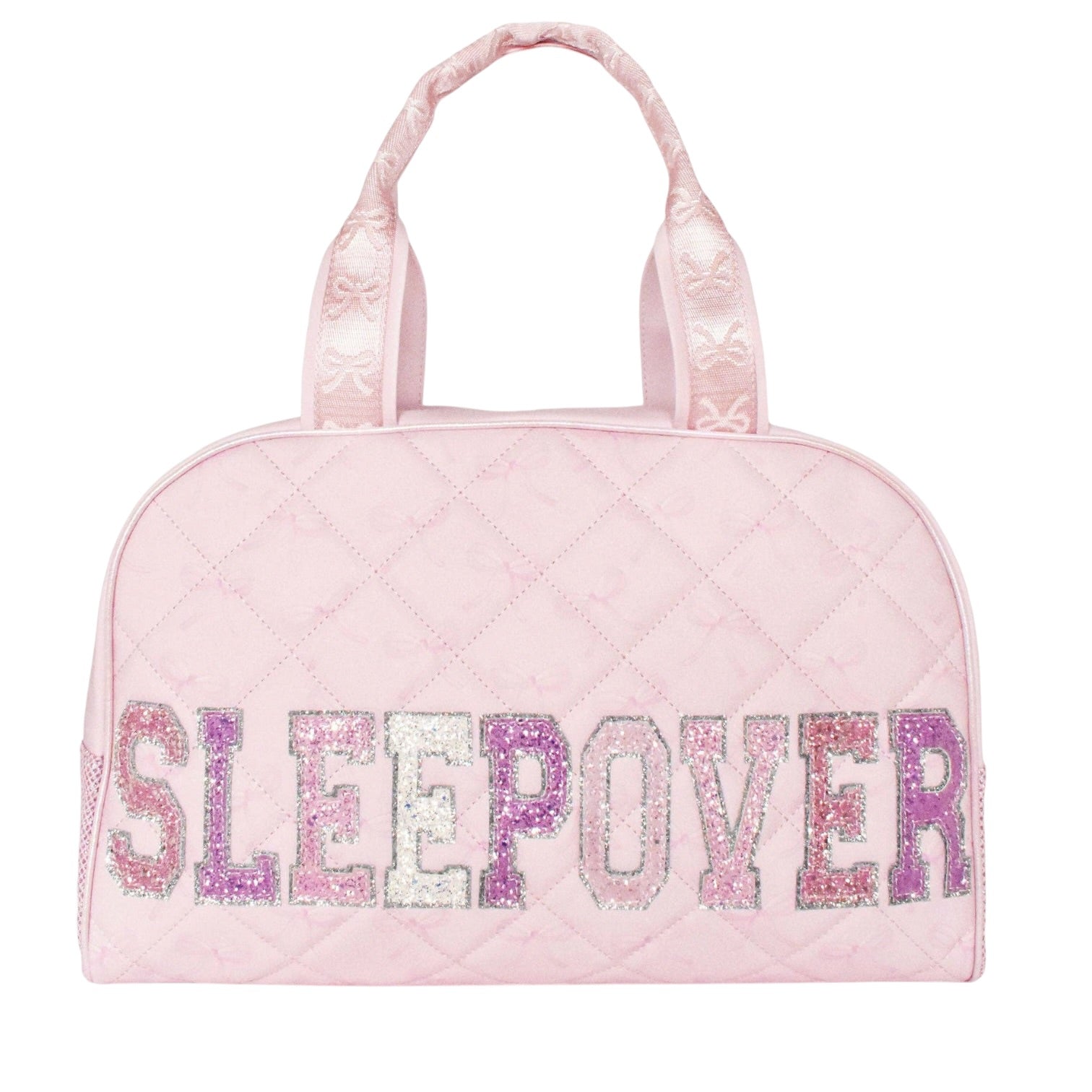 A light pink quilted duffle bag with the word 'SLEEPOVER' spelled out in glittery letters across the front. The bag has two top handles and is shown against a plain white background.