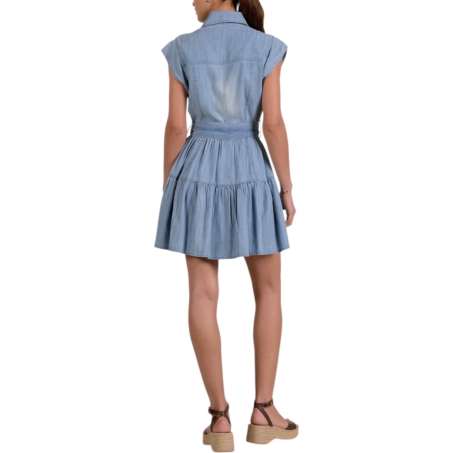 Woman wearing a blue denim dress on a white background