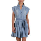 Woman wearing a blue denim dress on a white background