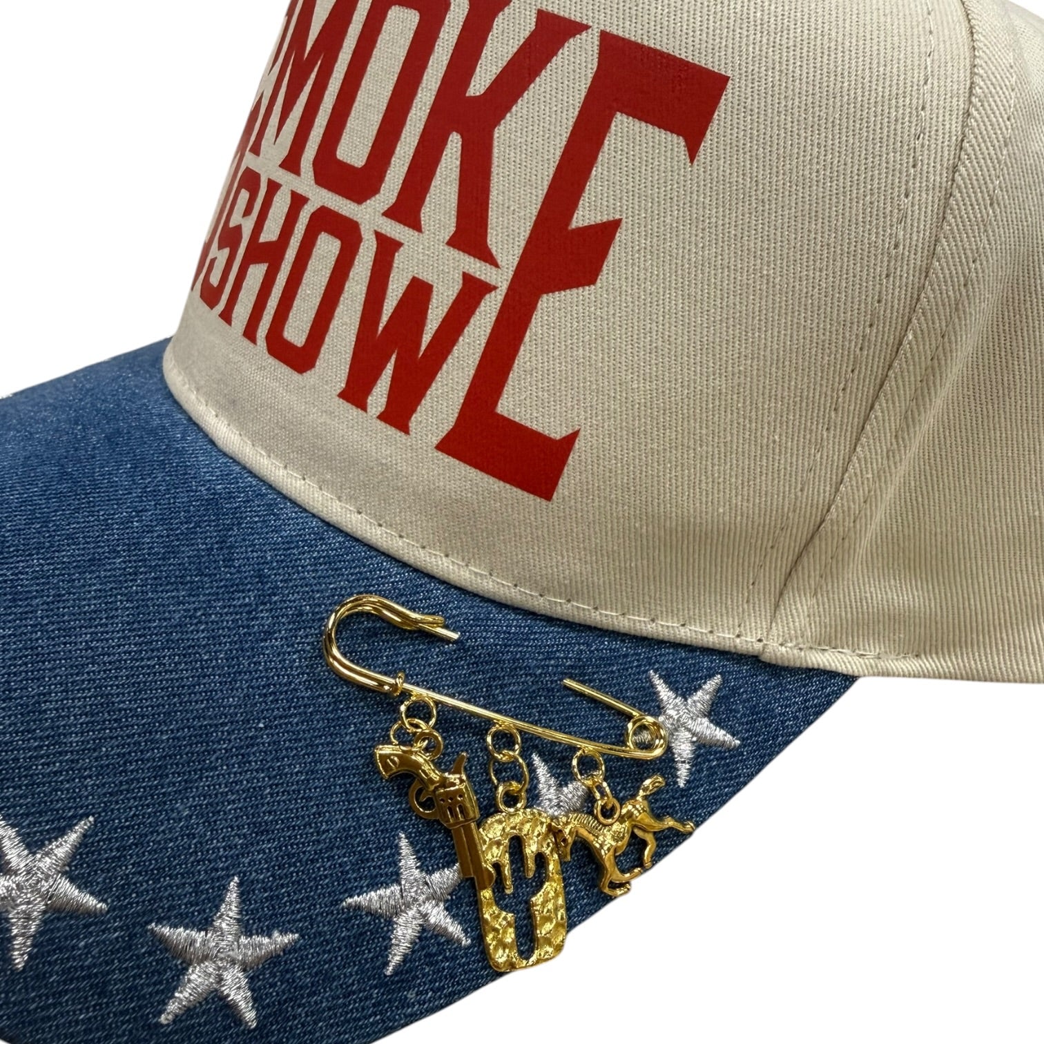 Cap with 'SMOKESHOW' text and gold charms on a white background