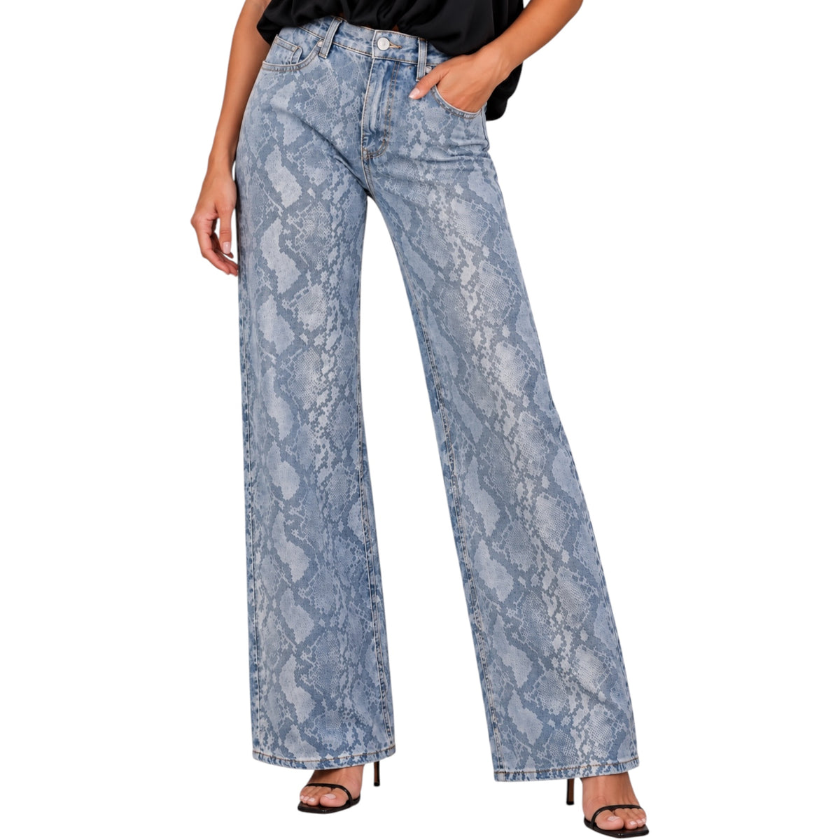 A person wearing light blue wide-leg jeans with a snakeskin pattern, paired with a black top and black heeled sandals, shown against a plain white studio background.