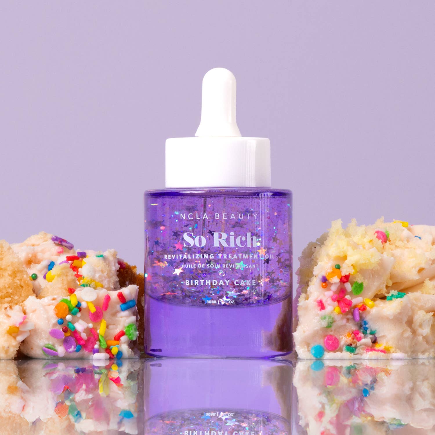 Purple bottle with white dropper labeled 'NCLA Beauty So Rich' on a reflective surface with colorful sprinkles.