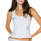 White tank top with starfish designs worn by a model on a white background