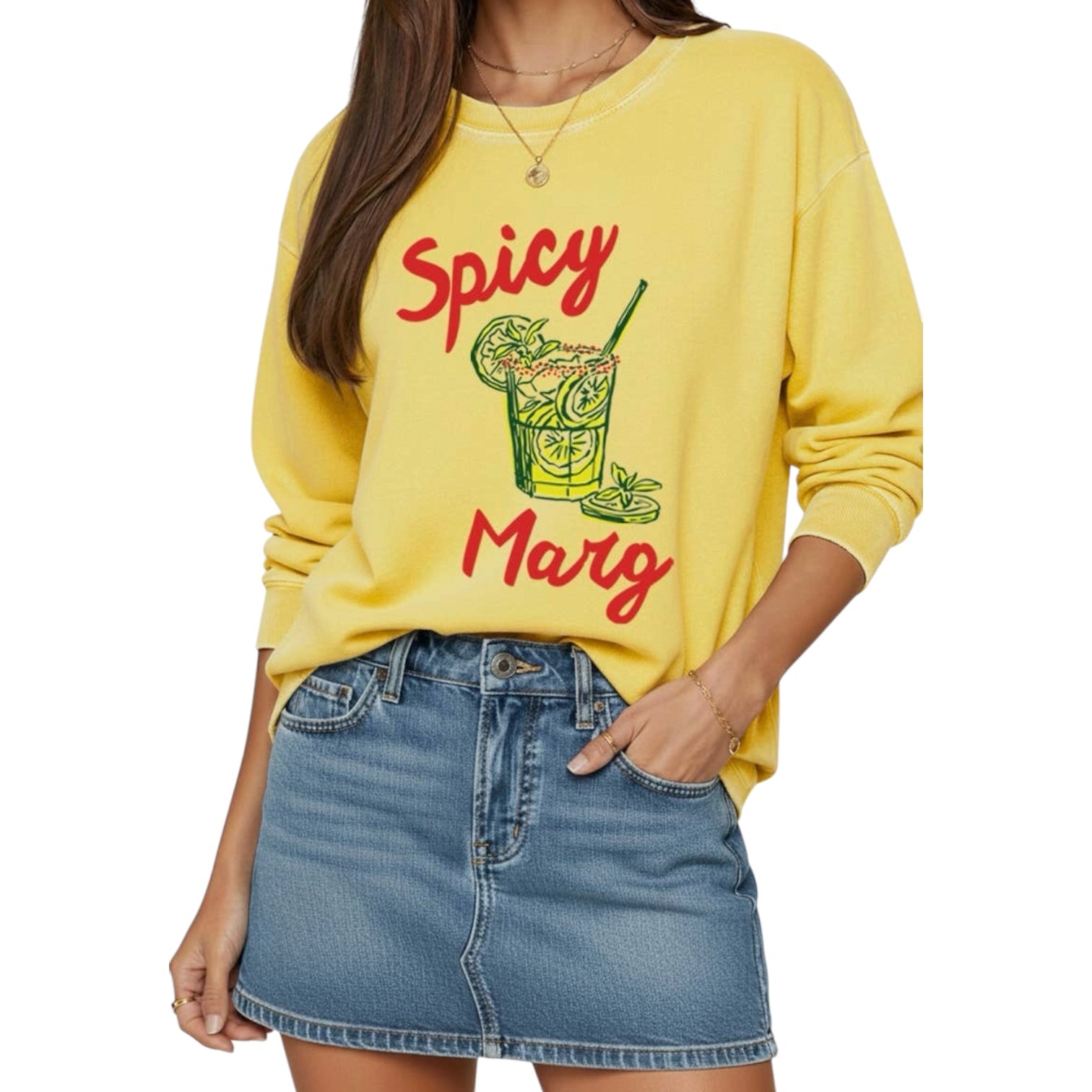 Person wearing a yellow sweatshirt with 'Spicy Marg' text and graphic, paired with a denim skirt on a white background.