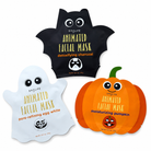 Three Halloween-themed facial mask packets on a white background: a black bat packet labeled 'detoxifying charcoal,' a white ghost packet labeled 'pore-refining egg white,' and an orange pumpkin packet labeled 'moisturizing pumpkin.' The brand name 'SPALIFE' is visible on each packet.