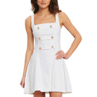White dress with gold buttons worn by a model on a white background