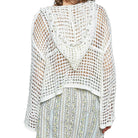 White crochet top worn by a person on a white background