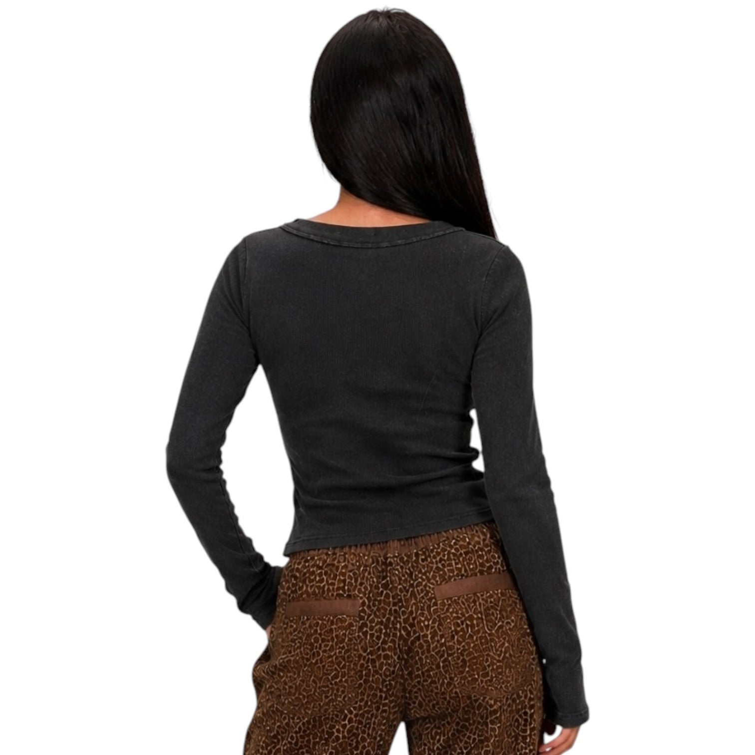 A woman shown from the back wearing a dark charcoal gray long-sleeve top and brown leopard-print pants against a plain white background.