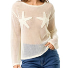 Beige mesh sweater with starfish designs worn by a person on a white background
