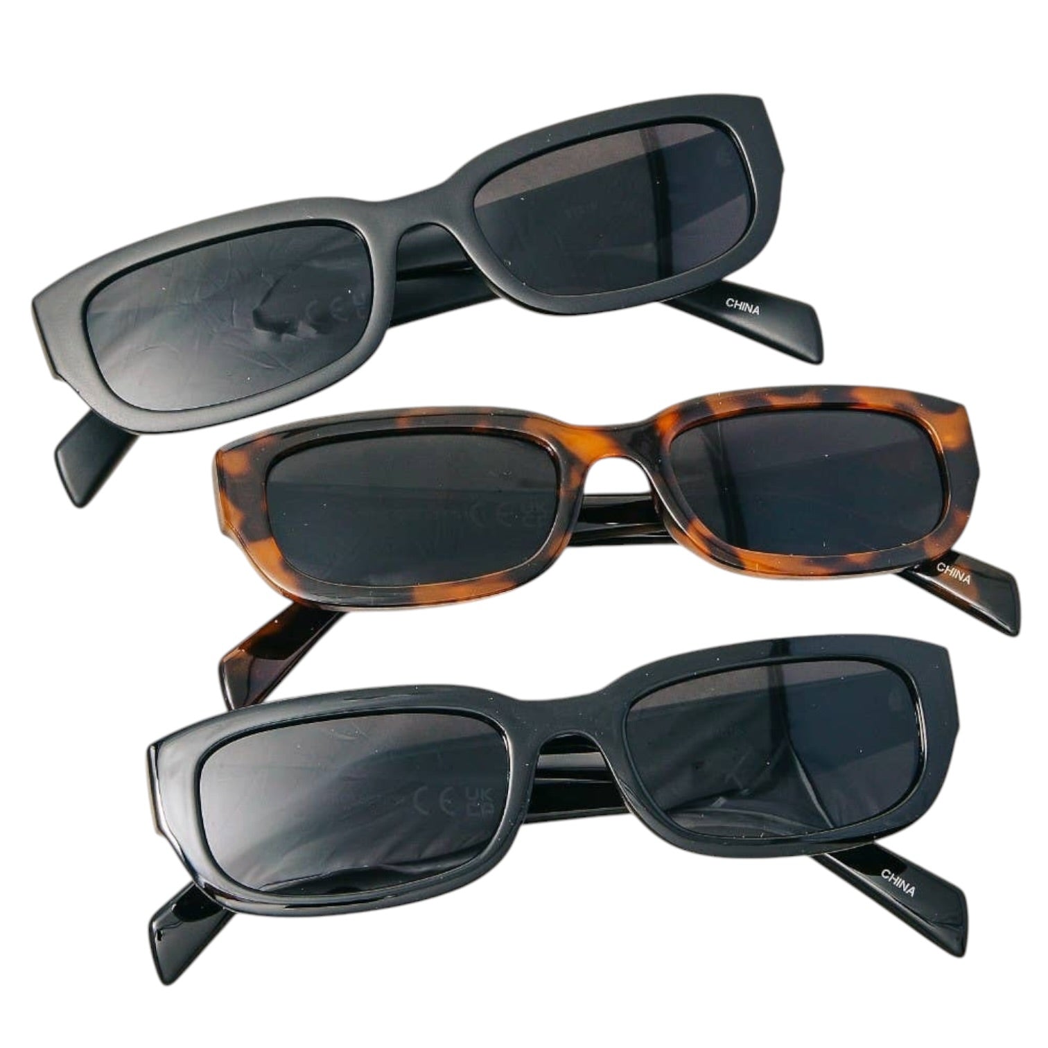Three pairs of sunglasses with different designs on a white background