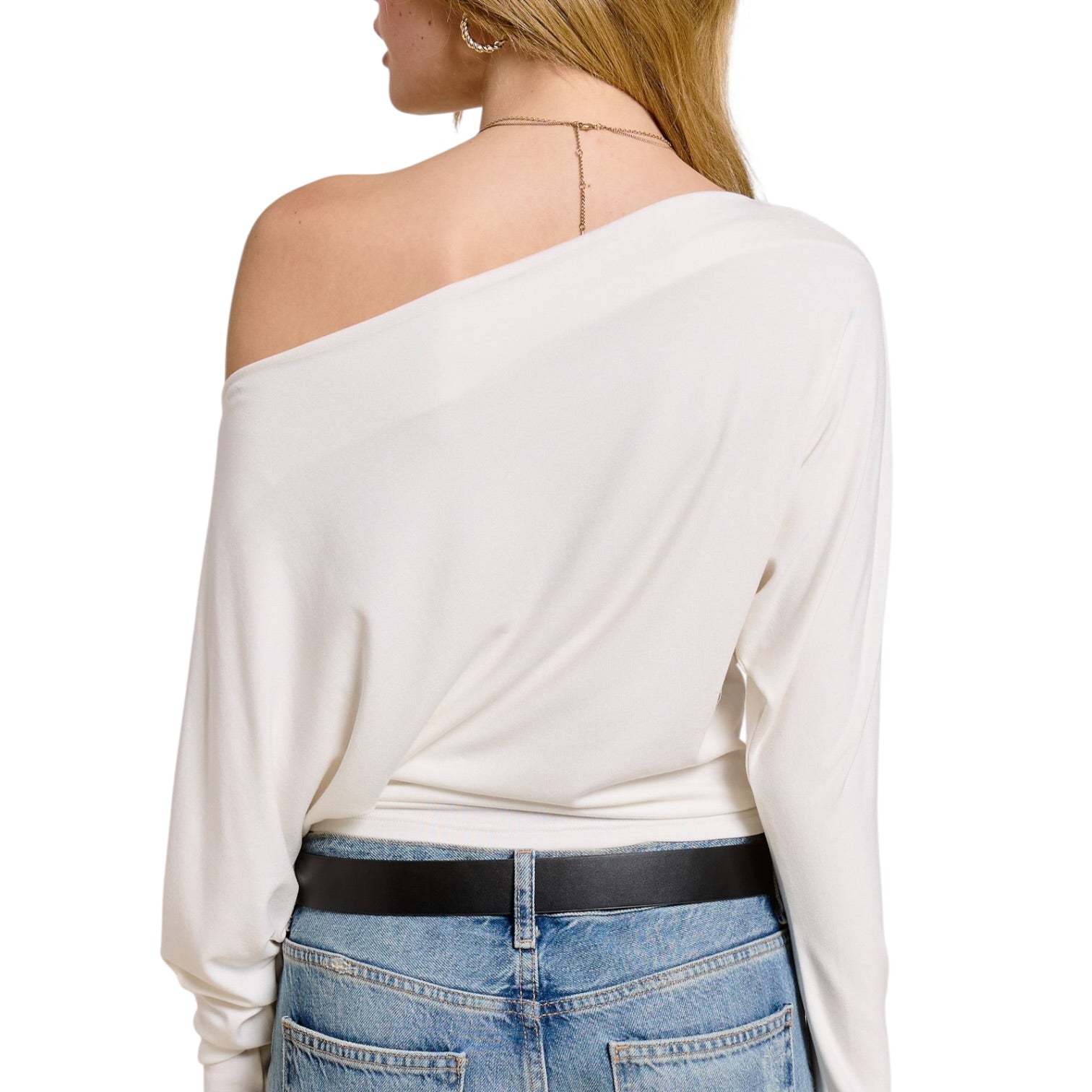 White off-shoulder top worn by a person on a white background